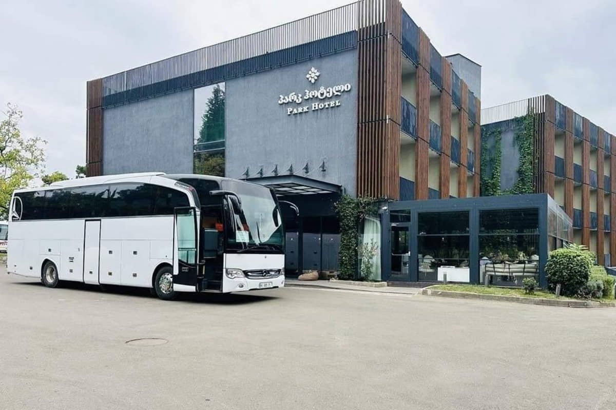46-seater bus rental in Tbilisi near hotel entrance for group transfer
